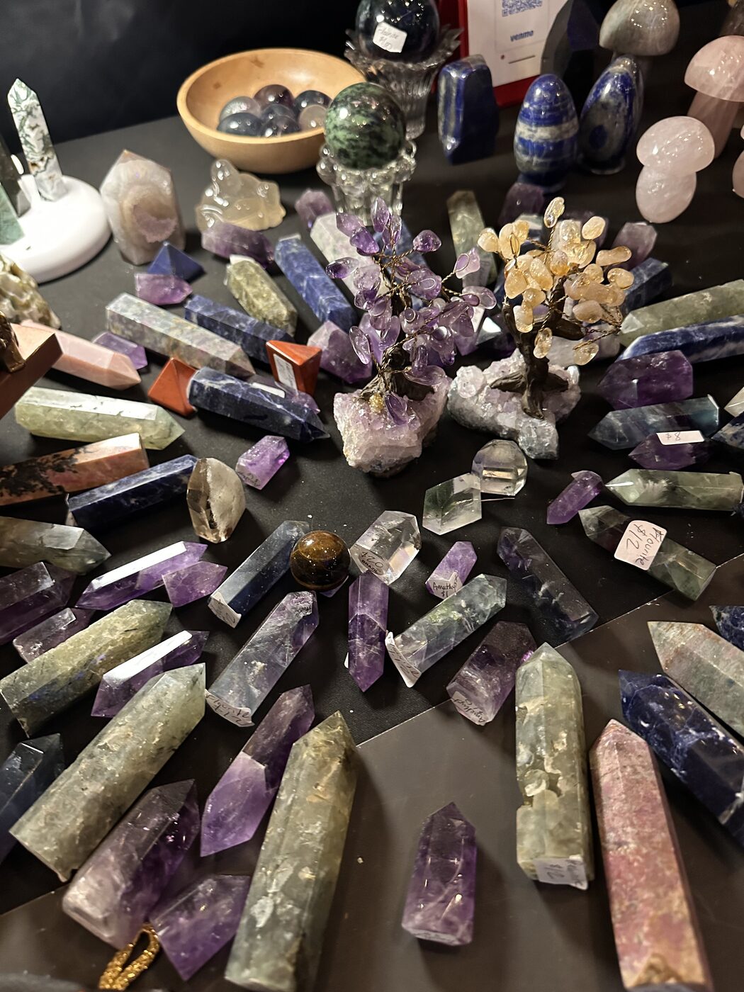 Polished crystal towers, wire gem trees and carved stone mushrooms arranged on a dark table